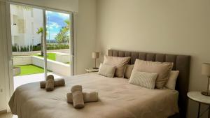 a bedroom with a large bed with a large window at Casa Rico in Guardamar del Segura +42 photos