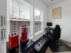 a living room with a black leather couch and a window at Retro Living! in Lewisville +9 photos