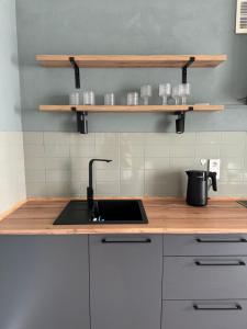 a kitchen with a sink and wooden counter top at Стильна і сучасна квартира з двома спальнями біля Дніпра! in Cherkasy +3 photos