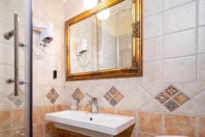 a bathroom with a sink and a mirror at Archontiko Eleni Hotel in Andros
