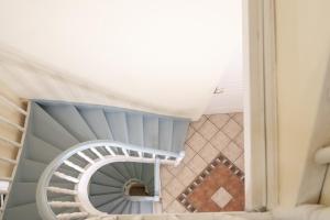 a spiral staircase in a house at Archontiko Eleni Hotel in Andros