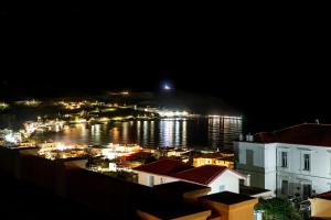 a view of a harbor at night with a city at Archontiko Eleni Hotel in Andros