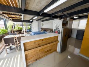 a kitchen with a counter top and a refrigerator at Dowtown lofts by flor y tierra in Guadalajara