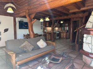 a living room with a couch and a table at Cabañas Las Nubes in San Carlos de Bariloche