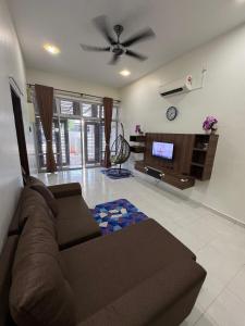a living room with a couch and a flat screen tv at FA homestay in Kuantan