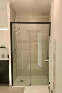 a shower with a glass door in a bathroom at La Suite Design Dunkerque Plage à 50 mTerrasse Sud in Dunkerque