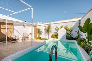 a swimming pool in a backyard with a house at La veleta in Gerena