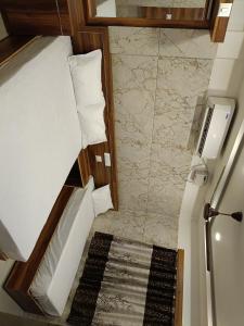 a small room with a bed and a bathroom at Leela Residency velankanni in Velankanni