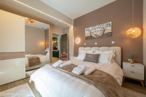 a large white bed in a room with a mirror at Serres Best For Rest in Serres +43 photos