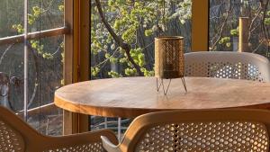 a wooden table and chairs in front of a window at Matea Slow Living Home Private Retreat in Čortanovci