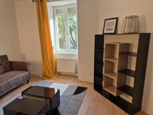 a living room with a couch and a coffee table at Le refuge du RDC in Seloncourt
