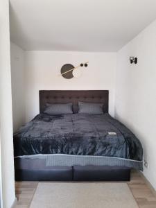a bedroom with a bed with a black comforter at Haus am See in Lindow