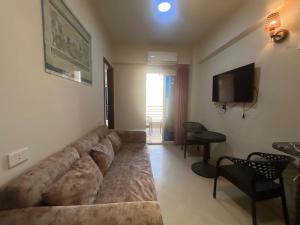 a living room with a large couch and a television at princess Resort Hurghada in Hurghada