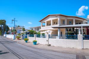 a building on the side of a street at Carambola Hotel with Pool Access, Steps to Beach in Christ Church
