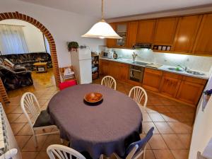 a kitchen and dining room with a table and chairs at Apartment Senik in Grgar +37 photos