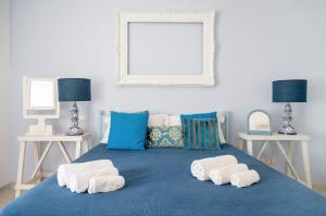 a bedroom with a blue bed with towels on it at Le Terrazze in Otranto