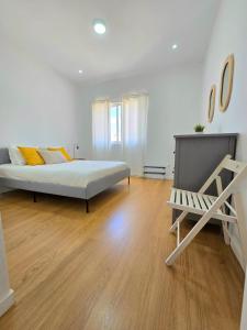 a bedroom with a bed and a chair in it at Casa Bela in Mindelo