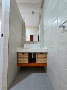 a bathroom with a sink and a mirror at Casa Bela in Mindelo +61 photos