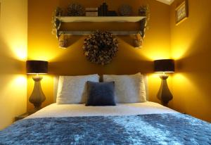 a bedroom with a large bed with two lamps at Hof van Benten in Ermelo +19 photos