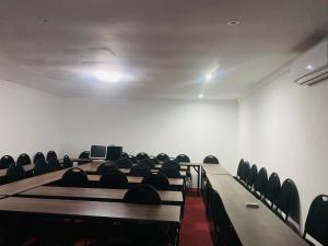 a room with rows of chairs and desks in a room at Dwengu Guest house in Margate