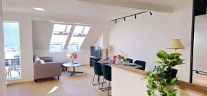 a living room with a table and chairs and a living room at Best view in town in Bergen