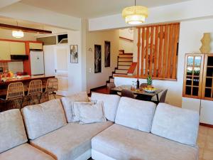 a living room with a couch and a kitchen at Villa Angelo Porto Heli - Private Pool in Porto Heli