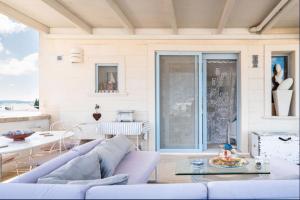 a living room with a couch and a table at Le Terrazze in Otranto