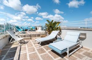 a balcony with lounge chairs and a view of the ocean at Le Terrazze in Otranto