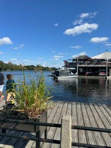 a dock with a boat on the water at The Dows retreat in Ottawa +25 photos