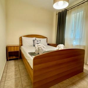 a bedroom with a bed with a teddy bear on it at Betty's House in Porto Rafti +3 photos