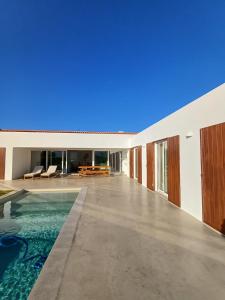 an image of a house with a swimming pool at Casa Fá - NEW T4 - Aljezur in Aljezur
