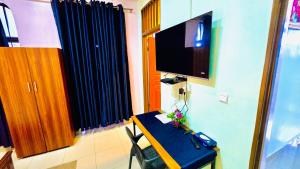 a room with a table and a television in a room at Gravity retreat in Kigali