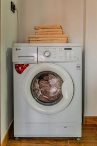 a washing machine with towels on top of it at M Apartment aproape de plaja in Mangalia