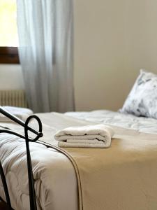 a bed with two towels sitting on top of it at PARISI SAN Vendemiano in Capo di Sotto