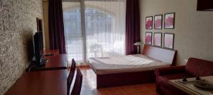 a small room with a bed and a window at GL Beach Resort Private Studio Sozopol in Sozopol
