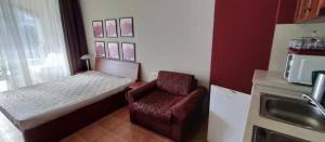 a small room with a chair and a microwave at GL Beach Resort Private Studio Sozopol in Sozopol