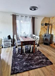 a dining room with a table and a fireplace at Haus am See in Lindow