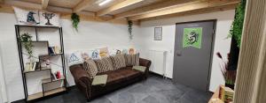 a living room with a brown couch and a door at Magisches Wachstein in Wachstein