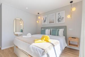 ein Schlafzimmer mit einem Bett und einem gelben Handtuch darauf in der Unterkunft Casa da Ilha in Funchal + 19 Fotos