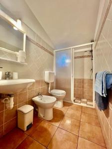 a bathroom with a toilet and a sink and a shower at Case Vacanze Maestrale in Fetovaia +58 photos