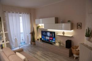 a living room with a couch and a flat screen tv at Casa Lucrezia - alla Torre in Viterbo