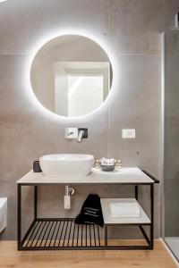 a bathroom with a sink and a mirror at Sole Luxury terrace,Central apartment in Matera