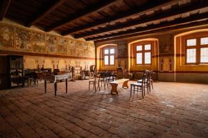 a room with chairs and tables in a building at Dům u Giordanu in Slavonice
