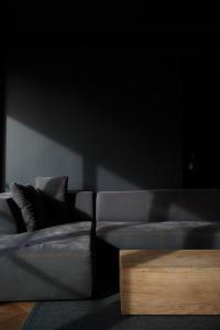 a living room with a couch and a coffee table at CrownPlaza Boutique & Central in Chişinău