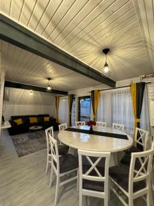 a living room with a table and chairs and a couch at LKS A-frame in Corbi