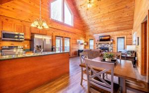 a kitchen and living room with a wooden ceiling at Wanderlust in Sevierville