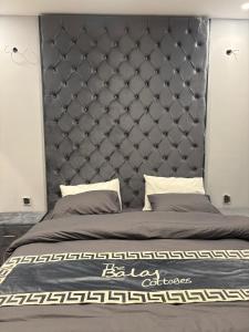 a bed with a large headboard in a bedroom at The Balaj Cottages in Kālābāgh +158 photos
