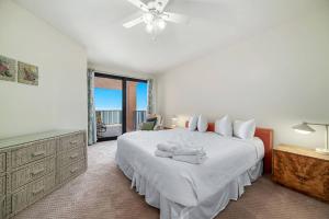 een witte slaapkamer met een groot bed en een raam bij Four Seasons 904W in Orange Beach