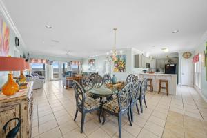 a dining room and kitchen with a table and chairs at Sea-Side in Dauphin Island