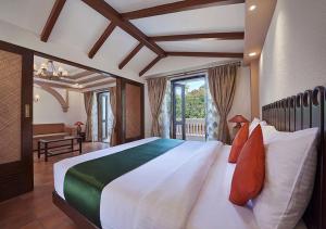 Postel nebo postele na pokoji v ubytování Ziva Suites - A Botique Hotel